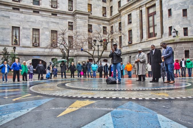 Solomon Jones leads “A Prayer for the City” with other clergy at the courtyard of City Hall Wednesday. (Kimberly Paynter/WHYY)