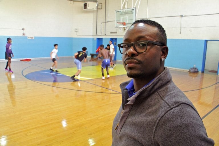 Trainee Quan King looks in on the open gym at Cobbs Creek Rec Center.