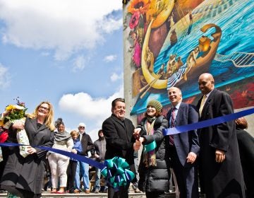 (From left) Artist Meg Saligman, Antonio Valdes, executive director of the Children’s Crisis Treatment Center, Jane Gold, Mural Arts executive director, Councilman Mark Squilla, and David T. Jones, DBHIDS commissioner, cut the ribbon on the “Rippling Moon” mural. (Kimberly Paynter/WHYY)