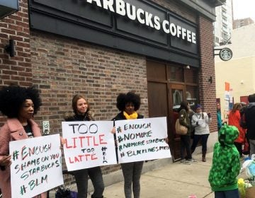 Protesters gather outside a Starbucks in Philadelphia, Sunday, April 15, 2018, where two black men were arrested Thursday after Starbucks employees called police to say the men were trespassing. The arrest prompted accusations of racism on social media. Starbucks CEO Kevin Johnson posted a lengthy statement Saturday night, calling the situation 
