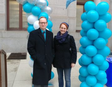 Michael Brossard and Kathryn Wylde speak during a WOAR rally Thursday at Philadelphia City Hall.  (Tom MacDonald/ WHYY)