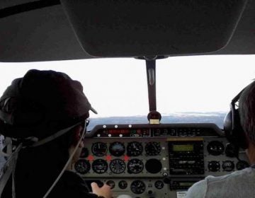 A pilot wears a wireless headband that tracks his brain activity, while flying a plane. Photo courtesy of ISAE-SUPAERO.