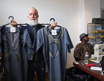 Bryan Norris, founder of the Refugee Makers Project in Lancaster, holds two caftans, which creator Remmy Kasongo calls bubus.