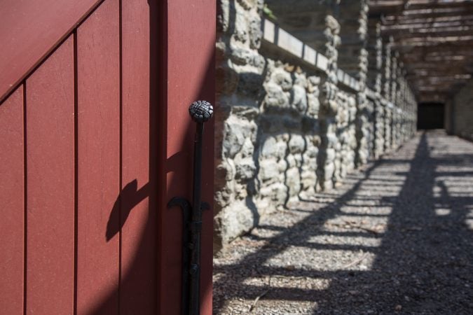 New custom iron work integrates seamlessly with the old stone work on the ground of Stoneleigh Gardens. (Emily Cohen for WHYY)