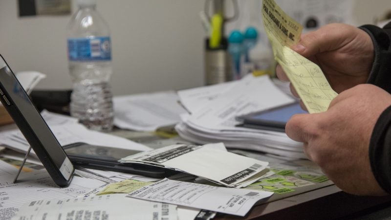 While Jimmy waits for his truck to arrive, he inputs his receipts into the Google document. (Emily Cohen for WHYY)