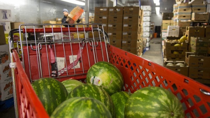 Watermelon, purchased the day before, makes its debut at the market as it is brought up from the basement. (Emily Cohen for WHYY)