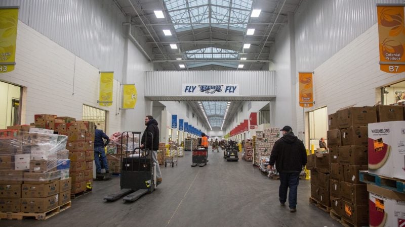 Jimmy makes his way through the long and chilly Philadelphia Wholesale Produce Center as he does his tri-weekly buy for his Reading Terminal Market store, Iovine Brothers Produce. (Emily Cohen for WHYY)