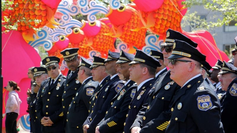 Philadelphia police officers stand in ranks for the Living Flame Memorial Service at Franklin Square. (Emma Lee/WHYY)