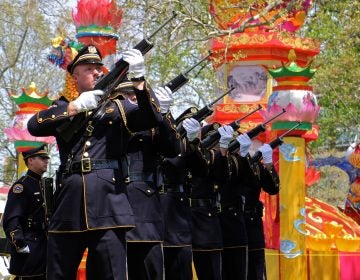 The Philadelphia Police and Fire Honor Guard fire a rifle salute in honor of fallen officers and firefighters.