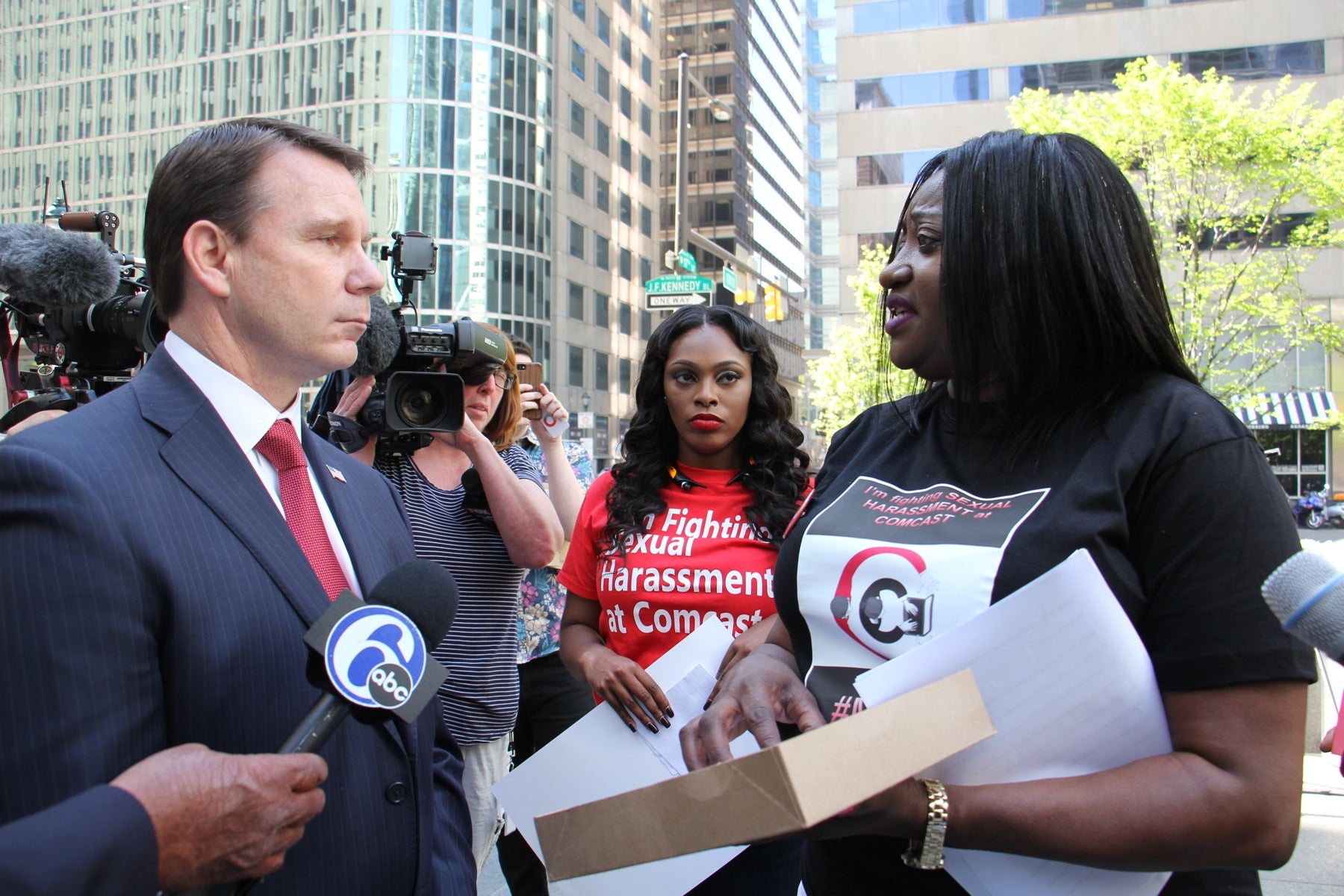 Rylinda Rhodes (right) is stopped by security as she attempts to deliver a petition to the Comcast human resourses department. Rhodes has filed a claim that she was sexually harrassed during the three years she worked as a call center in Maryland.