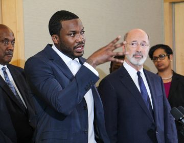 Rapper Meek Mill talks criminal justice reform with Pennsylvania Gov. Tom Wolf during a press conference at the National Constitution Center.