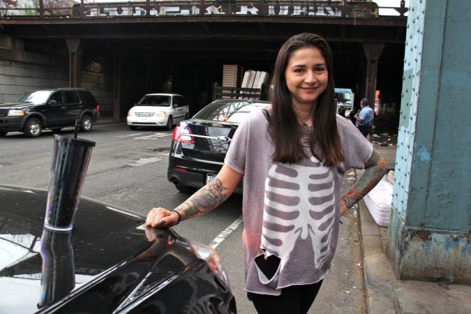 Outreach volunteer Nicole Bixler visits a camp at Kensington and Lehigh avenues. (Emma Lee/WHYY)