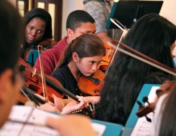 Meara Lim-Goyette, 11, (center) rehearses with Musicopia, for a performance of Mark Laycock's 