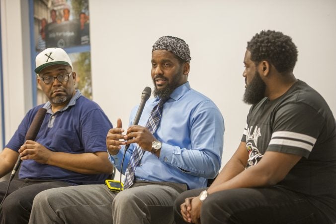 Moderator Michael Dennis, (left), Mujahideen Mohammed, and B. F. Nkrumah, (right), share their insights with the audience. (Jonathan Wilson for WHYY)