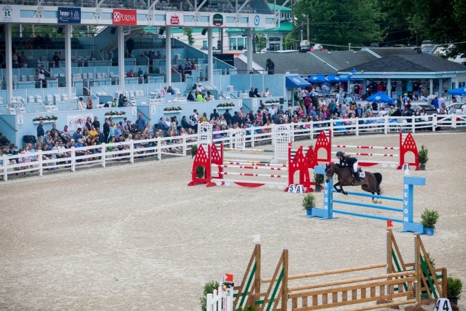 Ashyln Morelli jumps her horse Just One Look at the 122nd annual Devon Horse Show Sunday, May 27. (Brad Larrison for WHYY)