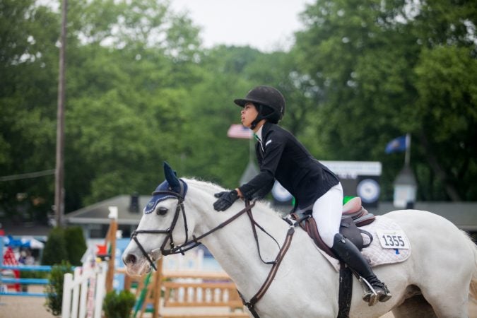 Hallie Rush rides her horse Sky Miles at the 122nd annual Devon Horse Show Sunday, May 27. (Brad Larrison for WHYY)