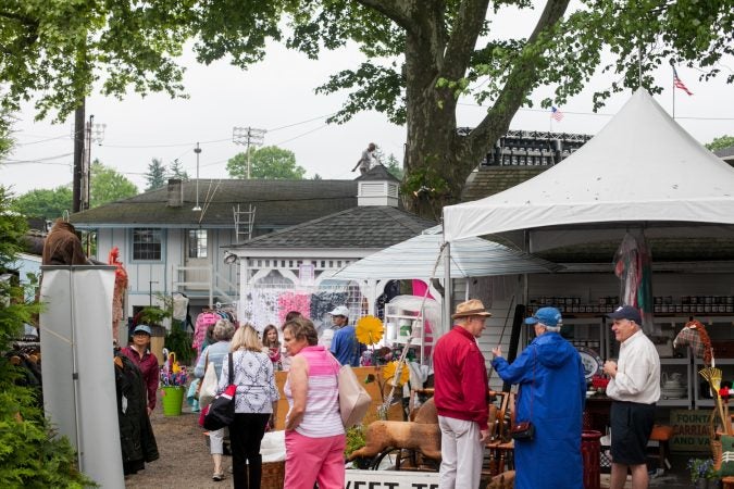 Vendors sell antiques and other goods at the country fair portion of the Devon Horse Show on Sunday, May 27. (Brad Larrison for WHYY)