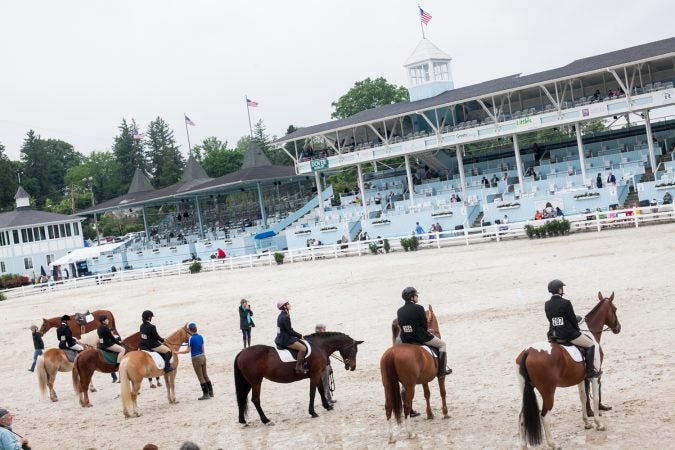 Riders line up in the main oval at the Devon Horse Show Sunday, May 27. (Brad Larrison for WHYY)