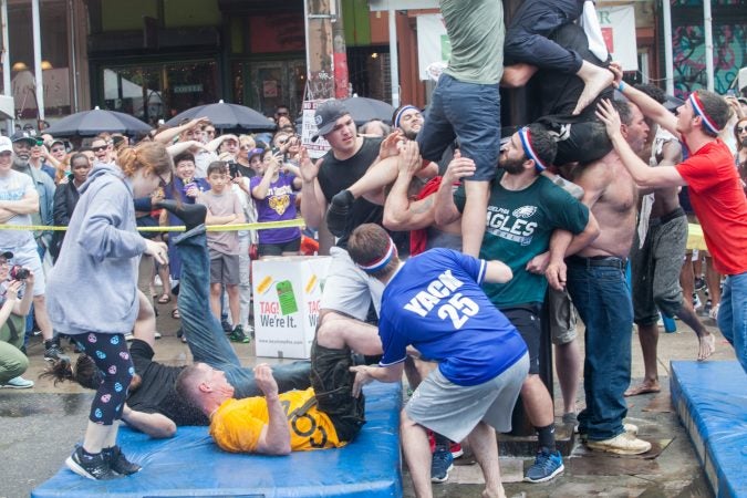 Team South Philly's base buckled under the weight after a successful ascension of the greased pole. (Brad Larrison for WHYY)