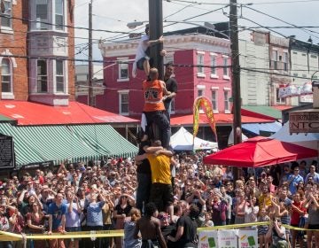 Team South Philly made another attempt at ascending the grease pole Sunday at the Italian Market Festival. (Brad Larrison for WHYY)