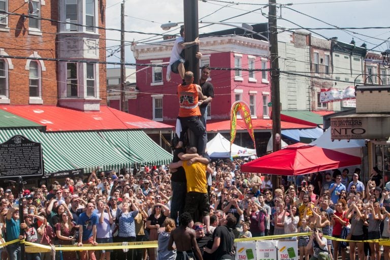 Team South Philly made another attempt at ascending the grease pole Sunday at the Italian Market Festival. (Brad Larrison for WHYY)