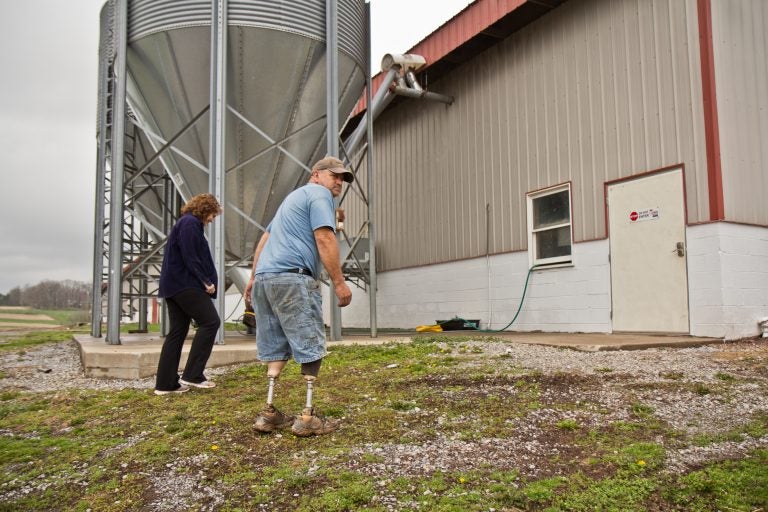 Dennis Hunsberger and his wife Lori at the chicken house on his farm. (Kimberly Paynter/WHYY)