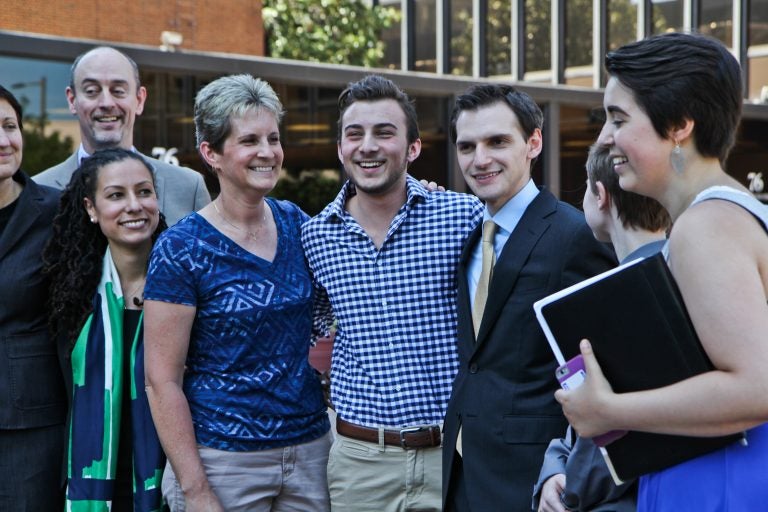 Aidan Destefano (center, checkered shirt) outside of the Philadelphia Federal Courthouse with his legal representation. (Kimberly Paynter/WHYY)