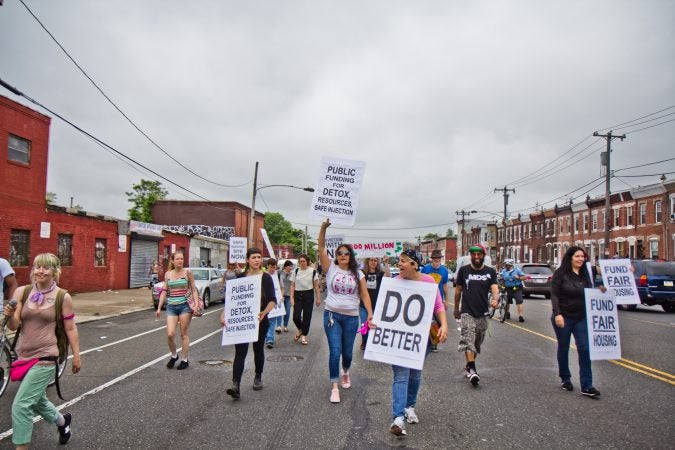 Protesters march down Lehigh Avenue in the Kensington section of Philadelphia an hour before the city began removing people and their belongings from encampments in Kensington. (Kimberly Paynter/WHYY)