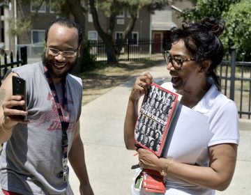 Congressional candidate Tanzie Youngblood holds up a Time magazine with her photo on the cover as Will Brant uses his phone to record a Snapchat story. Youngblood was campaigning at a low-income housing project in Bridgeton, New Jersey, on May 26, 2018.