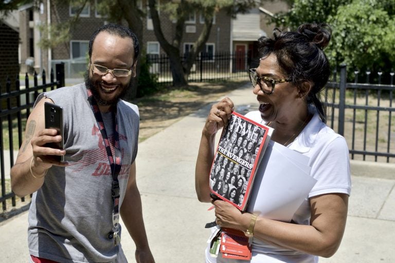 Congressional candidate Tanzie Youngblood holds up a Time magazine with her photo on the cover as Will Brant uses his phone to record a Snapchat story. Youngblood was campaigning at a low-income housing project in Bridgeton, New Jersey, on May 26, 2018.