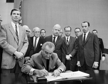 President Lyndon B. Johnson signs a gun control bill at the White House, Oct. 22, 1968. (AP Photo)