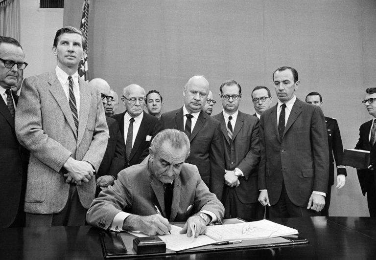 President Lyndon B. Johnson signs a gun control bill at the White House, Oct. 22, 1968. (AP Photo)