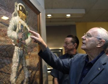 In this July 15, 2009 file photo, Apollo 12 astronaut Alan Bean walks through the largest exhibition of his artwork to date, inspired by his experience walking on the moon, to celebrate the 40th anniversary of the first Apollo moon landing, in Washington. Bean, the Apollo and Skylab astronaut, fourth human to walk on the moon and an accomplished artist, has died.  (Jacquelyn Martin/AP Photo, File)