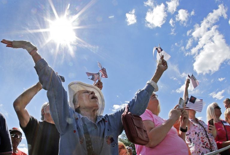 Ernestine Cuellar raises her hands in prayer during a rally on Boston Common in 2016. (Elise Amendola/AP Photo)