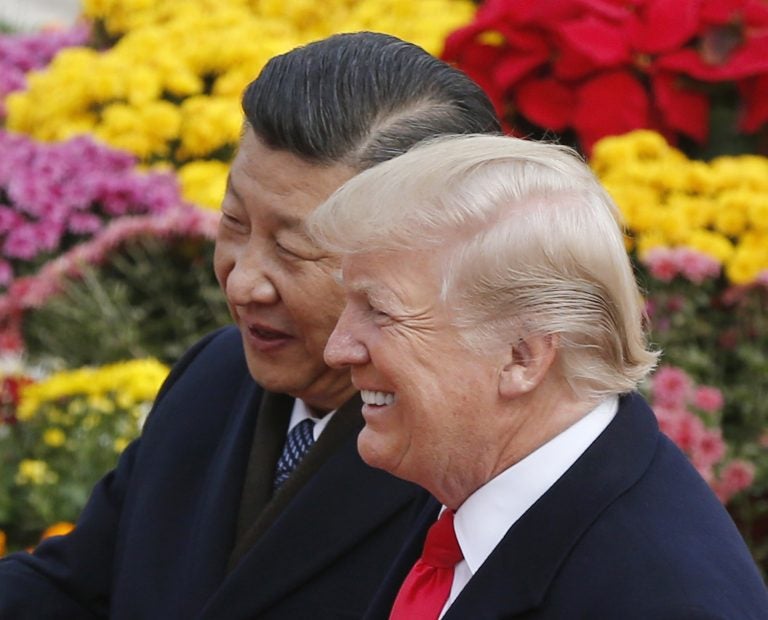 In this Nov. 9, 2017, file photo, U.S. President Donald Trump, right, chats with Chinese President Xi Jinping during a welcome ceremony at the Great Hall of the People in Beijing. (Andy Wong/AP Photo, File)