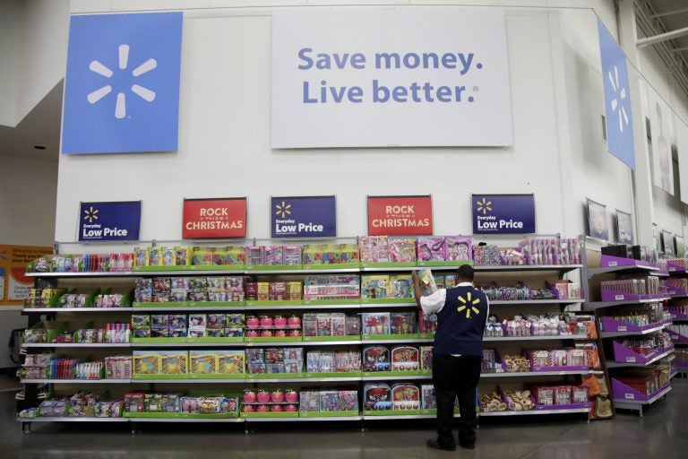 In this Thursday, Nov. 9, 2017, photo, Walmart employee Kenneth White scans items while conducting an exercise during a Walmart Academy class session at the store in North Bergen, N.J. (Julio Cortez/AP Photo)