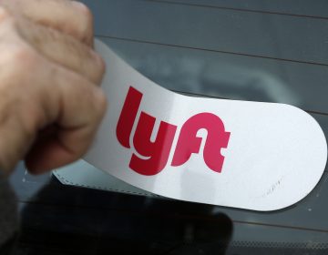 This is a Lyft logo being installed on a Lyft driver's car on Wednesday, Jan. 31, 2018 in Pittsburgh. (Gene J. Puskar/AP Photo)