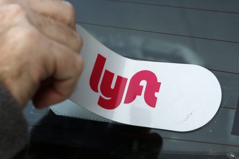 This is a Lyft logo being installed on a Lyft driver's car on Wednesday, Jan. 31, 2018 in Pittsburgh. (Gene J. Puskar/AP Photo)