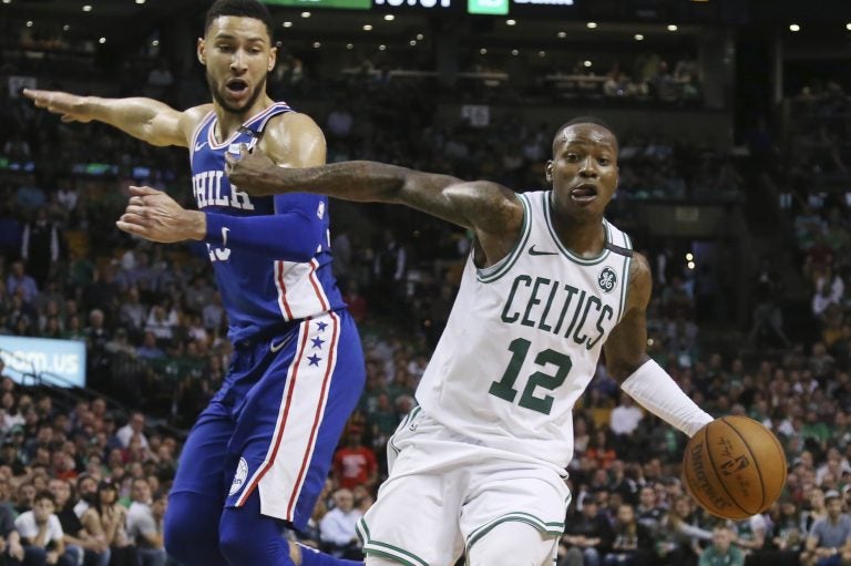 Boston Celtics guard Terry Rozier (12) dribbles by Philadelphia 76ers guard Ben Simmons in the second half of Game 2 of an NBA basketball second-round playoff series, Thursday, May 3, 2018, in Boston. The Celtics won 108-103. (AP Photo/Elise Amendola)