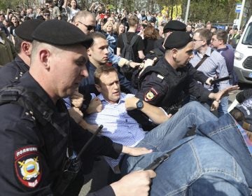 Russian police carrying a struggling opposition leader Alexei Navalny, center, at a demonstration against President Vladimir Putin in Pushkin Square in Moscow, Russia, Saturday, May 5, 2018. Thousands of demonstrators denouncing Putin's upcoming inauguration into a fourth term gathered Saturday in the capital's Pushkin Square. (AP Photo)