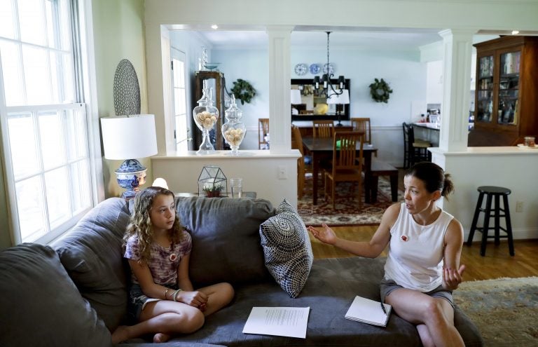 In this Thursday, May 3, 2018 photo, Sandy Nissenbaum, (right), and her daughter, Nora Nissenbaum, 12, talk during an interview with The Associated Press in Wayne, Pa. The case of a suburban Philadelphia boy who was quietly allowed to return to class after being accused of making a shooting threat has thrown a spotlight on the hard decisions school authorities must make. Nora Nissenbaum who says the boy bullied her has withdrawn from class for fear of him. (Matt Slocum/AP Photo)