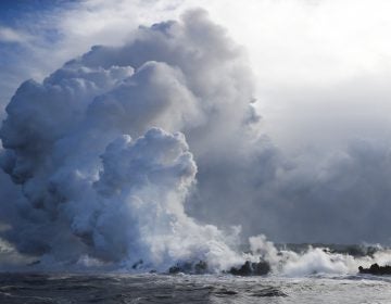 Plumes of steam rise as lava enters the ocean near Pahoa, Hawaii Sunday, May 20, 2018. Kilauea volcano that is oozing, spewing and exploding on Hawaii's Big Island has gotten more hazardous in recent days, with rivers of molten rock pouring into the ocean Sunday and flying lava causing the first major injury