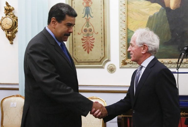 In this photo released by the Miraflores Presidential Press Office, Venezuela's President Nicolas Maduro, left, shakes hands with Republican Senator Bob Corker during a meeting at the Miraflores Presidential Palace in Caracas, Venezuela, Friday May 25, 2018. The Chairman of Senate Foreign Relations Committee met with Venezuelan President Nicolas Maduro two days after the embattled socialist leader kicked out the top U.S. diplomat in the country. There was no immediate comment from Republican Senator Bob Corker's office about the nature of the surprise visit. (Miraflores Presidential Press Office via AP)