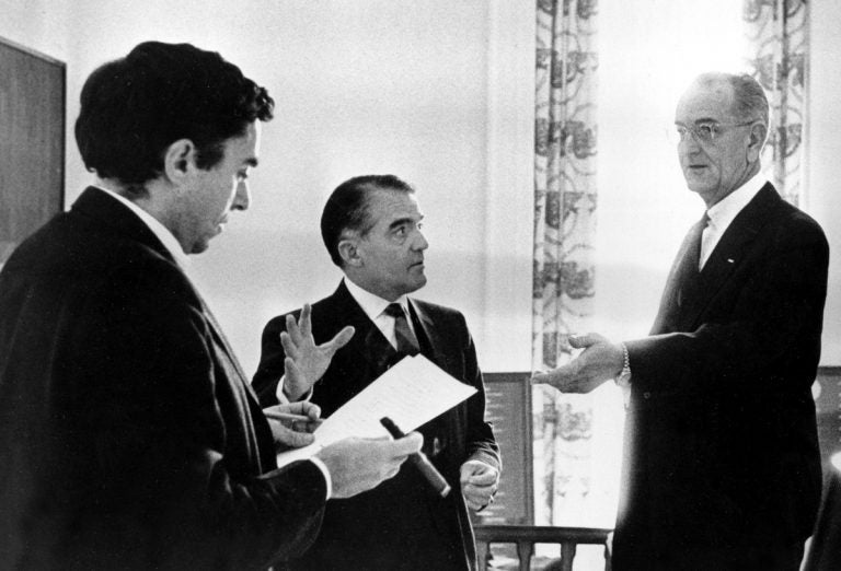 In this Jan. 12, 1966, photo provided by the White House, President Lyndon B. Johnson prepares for his State of the Union address with, (from left), Richard Goodwin, former presidential assistant called back from Wesleyan University to help on the speech, Jack Valenti and (not pictured) Joseph A. Califano, Jr. at the White House in Washington. Goodwin, an aide, speechwriter and liberal force for the Kennedys and Lyndon Johnson died Sunday, May 20, 2018, at his home in Concord, Mass. His wife, the historian Doris Kearns Goodwin, said he died after a brief bout with cancer. (The White House/AP Photo)