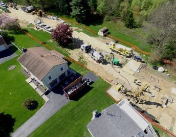 Mariner East 2 pipeline construction crews work in the backyards of homes on Lisa Drive in West Whiteland Township, Chester County, on May 2. Sinkholes that opened in the area prompted the state’s Public Utility Commission to order that an existing pipeline nearby, the Mariner East 1, be shut down until it could be determined that the sinkholes didn’t threaten its safety. PUC on May 3 approved a re-start of Mariner East 1 which will now be shut down again following a judge’s order. (Marie Cusick/StateImpact Pennsylvania)