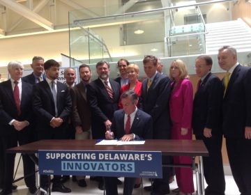 Gov. John Carney signs legislation that aims to incentivize startup businesses in Delaware. (Zoe Read/WHYY)