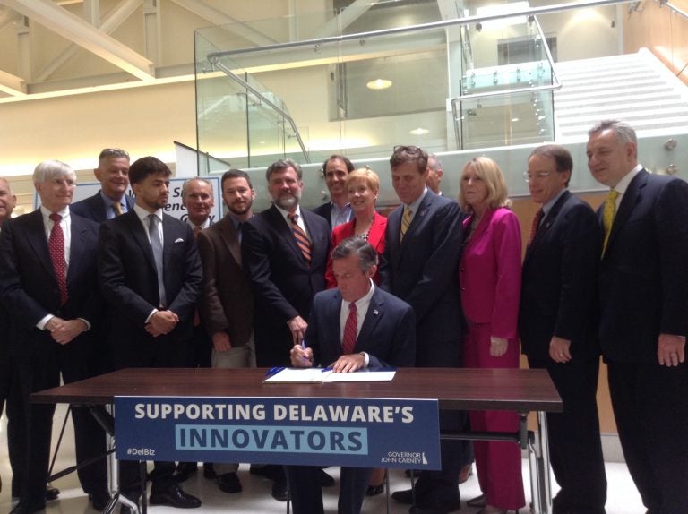 Gov. John Carney signs legislation that aims to incentivize startup businesses in Delaware. (Zoe Read/WHYY)