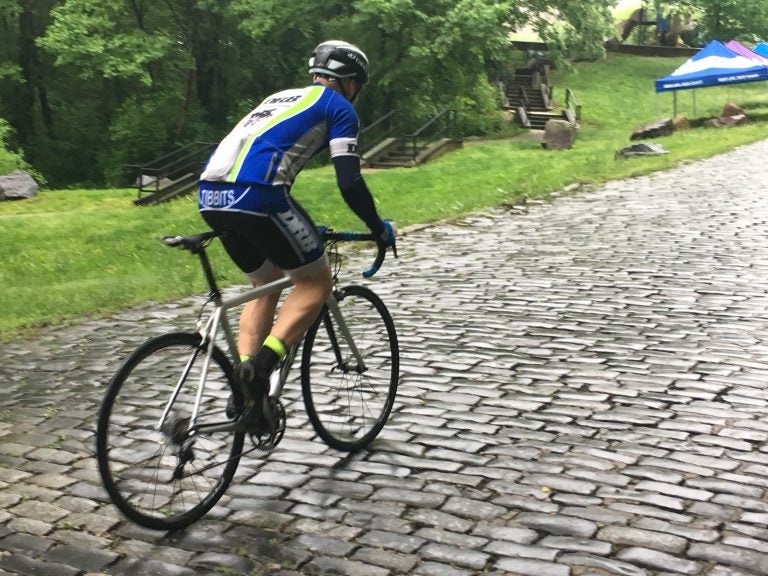 Injured Iraq war vet Brian Tibbits bikes his way up Monkey Hill in Wilmington in preparation for the Wilmington Grand Prix. (Mark Eichmann/WHYY)