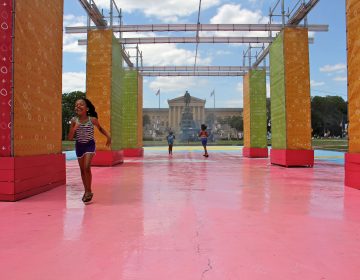 Children run through the mister at the Eakins Oval pop-up park.