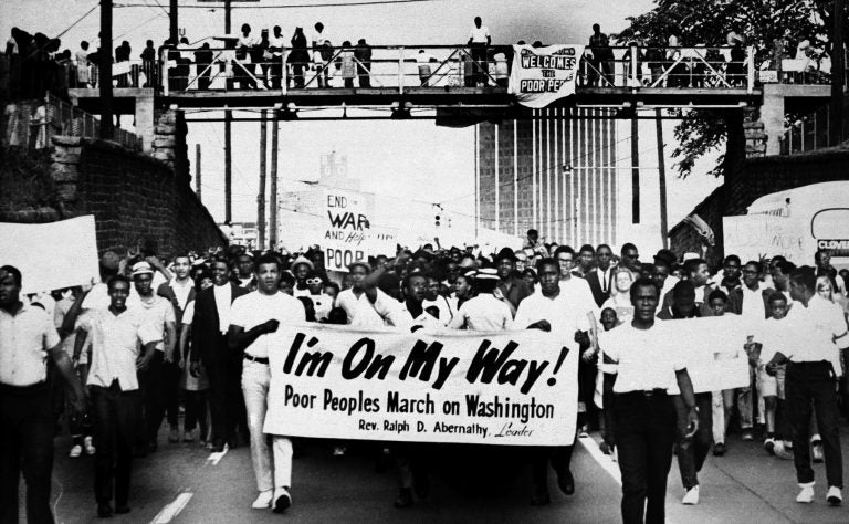 Sign-carrying participants march on the southern leg of the Poor People's Campaign May 10, 1968, in Atlanta. (AP file photo)